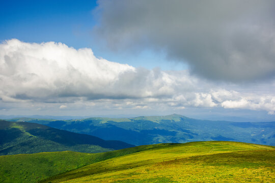 mountain meadow in the afternoon light. beautiful landscape with clouds above horizon. wonderful nature background.