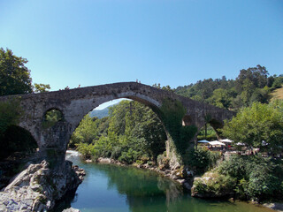 Old Roman stone bridge in Cangas de Onis (Asturias), Spain. Horizontal photography.