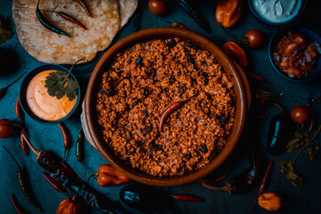 mexican pork meat for burritos and nachos with cheddar cheese and pico de gallo