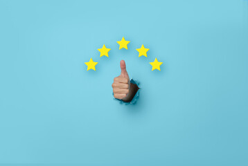 Customer Experience Woman hand thumb up vote on five star excellent rating on blue background....