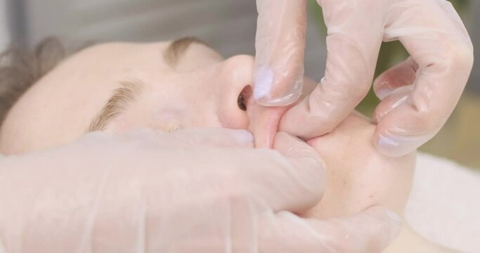 Deep facial and lip massage in the spa salon. close-up. Hands masseuse do a beautiful woman massage. Beauty and health procedure