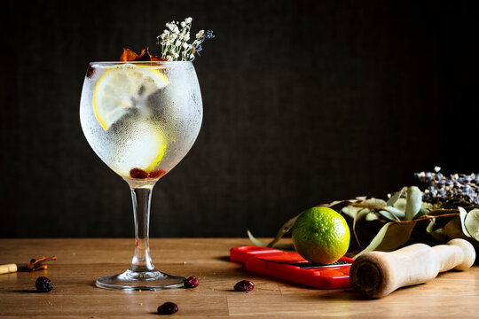 Freshly Prepared and Garnished Gin and Tonic on a Wooden Table