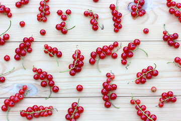 bunches of red currants on a wooden surface.