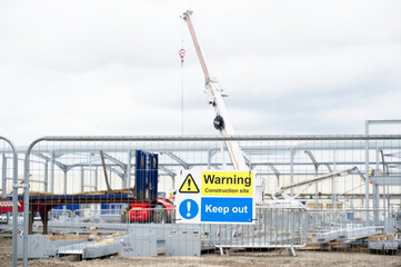 Construction site health and safety message rules sign board signage on fence boundary
