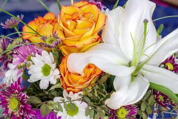Multi-colored bouquet with lily flowers and orange roses