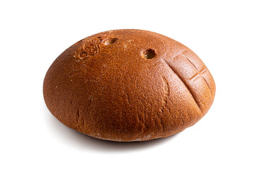 Round loaf of rye bread with a brown crust on white