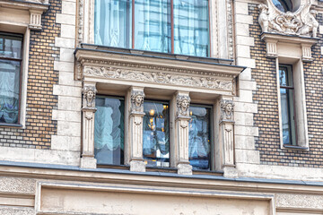 Window of a merchant's apartment house with pilasters and a decorative frieze - obrazy, fototapety, plakaty