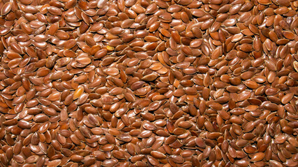 Flax grains background.The texture of flax grains is a top view.