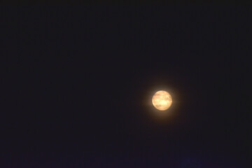 Full moon and clouds in the late evening