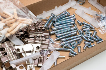 cardboard box with fittings in packets for furniture assembly at home