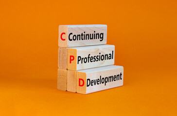 CPD, continuing professional development symbol. Wooden blocks with words CPD, continuing professional development on beautiful orange background. Business, CPD concept.