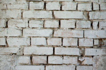 Abstract old white brick wall. background facade brick wall black and white. Vintage old brick wall texture. Grunge stone wall horizontal background. Dilapidated building facade with damaged plaster.