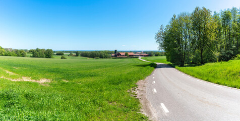 Idyllic Asphalt Country road in agricultural landscape, Skaraborg county near Kinnekulle in South Sweden.