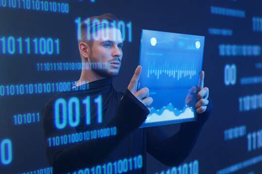 Man with futuristic tablet in hand. Guy using VR glasses. Augmented reality, future technology concept. Blue neon light. Futuristic holographic interface to display data.