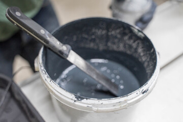 white plastic jar with dark paint