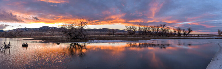 Sunset Winter Lake - A colorful winter sunset at a half-frozen bay of a mountain lake. Chatfield...