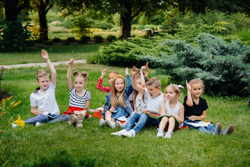A teacher teaches a class of children in an outdoor Park. Back to school, learning during the pandemic