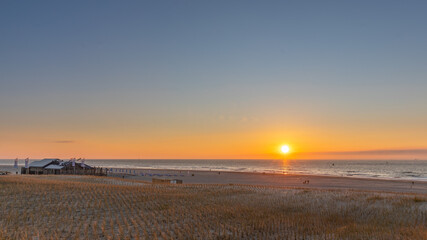 Sunset on the beach, Dutch beach wadden island Vlieland blue and orange sky sand dunes and restaurant