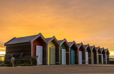 The vibrant and colorful beach huts by the promenade overlooking Blyth beach with a lovely sunset in Northumberland, England © Paul Jackson