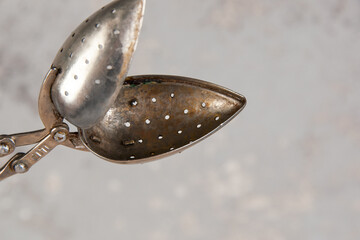 Old tea strainer on concrete background.