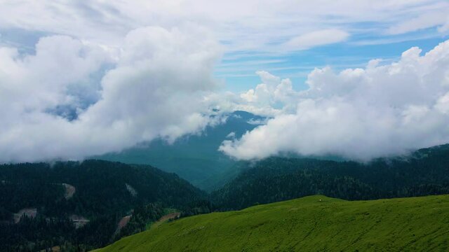 Mountain peaks with clouds. Aerial drone view. Rosa Khutor, Sochi, Russia. Caucasus mountains. Beautiful summer landscape. 4k
