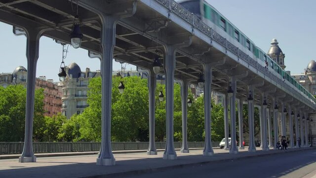 Bir-Hakeim bridge, Paris, France. Subway Train Passing Over The Bir Hakeim metallic Bridge At Daytime In Paris, France. wide shot, low angle.