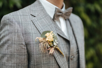 Groom wearing a boutonniere close-up