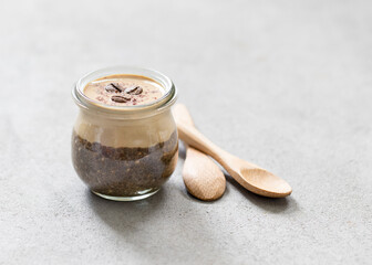 Obraz na płótnie Canvas Coffee pudding chia seeds with cottage cheese cream in a glass jar on light background