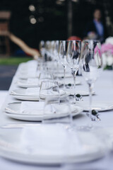 tableware Glasses, flower fork, knife served for dinner in restaurant with cozy interior
