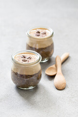 Obraz na płótnie Canvas Dessert in a glass jar, coffee pudding chia seeds with cottage cheese cream