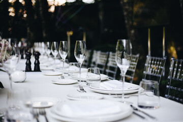 tableware Glasses, flower fork, knife served for dinner in restaurant with cozy interior