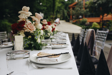 tableware Glasses, flower fork, knife served for dinner in restaurant with cozy interior