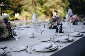 tableware Glasses, flower fork, knife served for dinner in restaurant with cozy interior