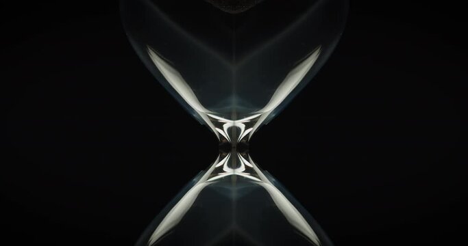 Abstract shot of sand pouring in hourglass and a white smoke wrapped around it. Close up. 