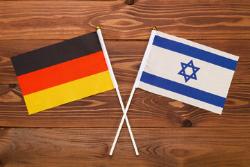 Flag of Germany and flag of Israel crossed with each other. The image illustrates the relationship between countries. Photography for video news on TV and articles on the Internet and media. - Powered by Adobe