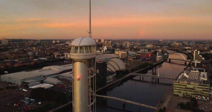 Aerial drone view, along the River Clyde, in Glasgow skyline at sunset. Views over city and landmarks. 4k