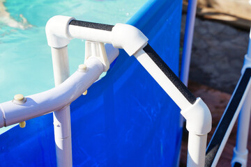 Non-slip tape sticker adhesive tape on a homemade pool ladder in the garden. Anti slippery surface