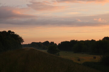 Naklejka na ściany i meble Sunset over farmland in Poland.