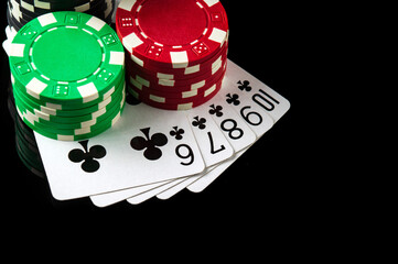 Poker game with straight flush combination. Chips and cards on the black table in poker club