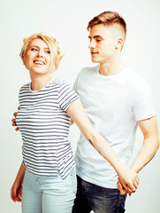 young pretty teenage couple, hipster guy with his girlfriend happy smiling and hugging isolated on white background, lifestyle people concept