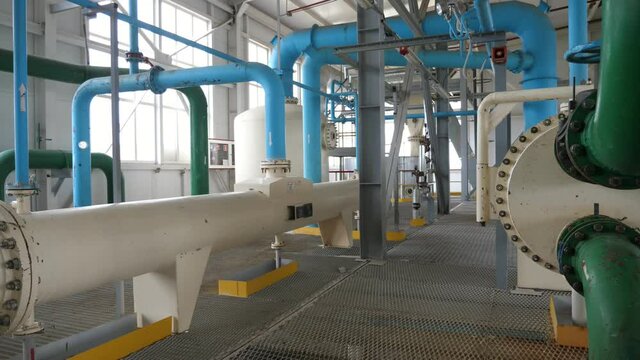 Nowaday gas station with two wide white tubes and narrow green pipes fixed to them  
