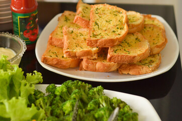 Western Food Dish Background with garlic bread, donuts, vegetables, french fries, slices fried chicken and slices beef steak