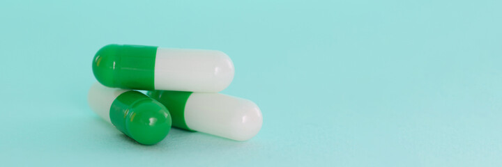 White-green pills on blue background. Development of the pharmaceutical industry