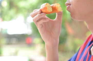 cropped man's hand eating donut