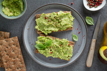 Tasty fresh toast with mashed avocado