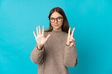 Young Lithuanian woman isolated on blue background counting seven with fingers