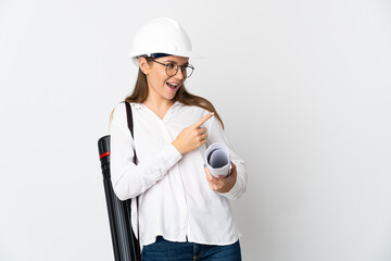 Young Lithuanian architect woman with helmet and holding blueprints isolated on white background pointing finger to the side and presenting a product