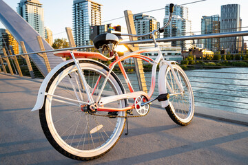 A vintage ladies cruiser bicycle parked on a pedestrian walkway over the Bow River in Calgary Alberta Canada.