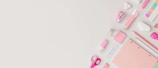 Pink school stationery on a grey background. Top view. Flat lay. Back to school concept.