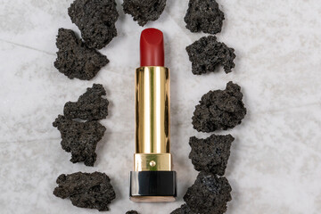red lipstick with a minimalist design and volcanic congealed lava from an active volcano